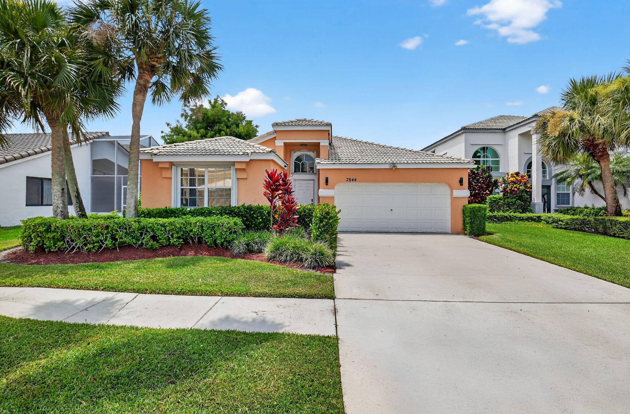 STUNNING WATERFRONT HOME SET ON AN EXPANSIVE CURVE OF A BEAUTIFUL LAKE WITH AN EXTENDED PATIO, SCREEN ENCLOSURE AND A LARGE PRIVATE BACKYARD.