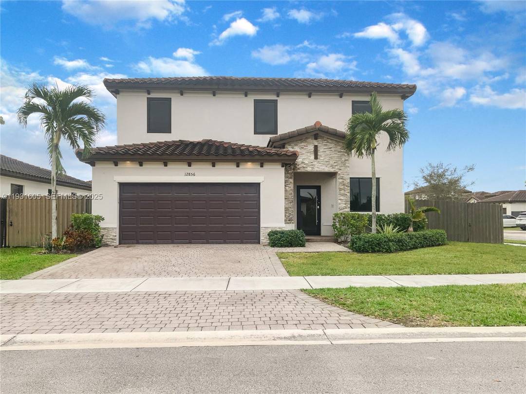 Welcome to your dream home located at 12856 SW 227th St, where the living room centers around a charming fireplace that sets a warm, inviting tone.