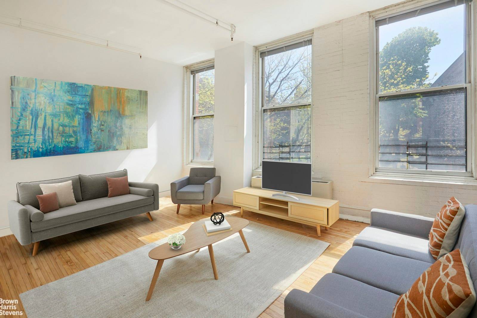 This exceptional Soho loft is boasting soaring ceilings, custom handcrafted woodworking throughout, exposed beams, and other original touches.