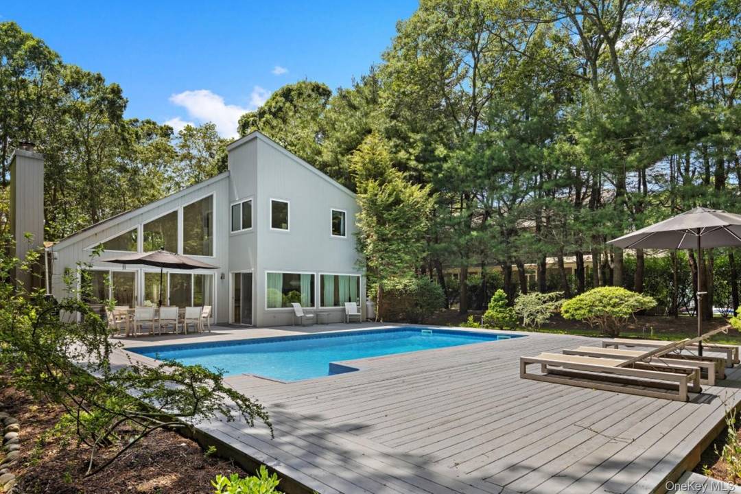 Quogue Mid Century Modern with Pool Set on a half acre in Quogue, this refreshed mid century modern offers soaring ceilings, abundant light, and an open, airy layout.