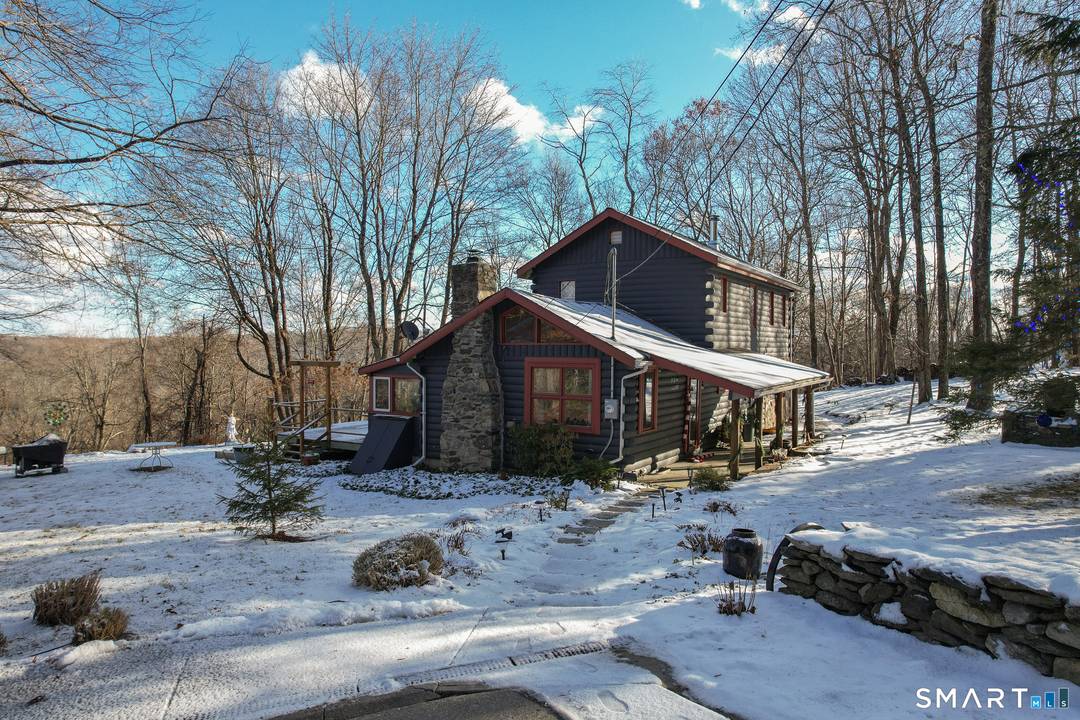 Welcome to this beautiful log cabin style Colonial, accented by charming stonework along the lower exterior and set atop a mountaintop with breathtaking, million dollar views.