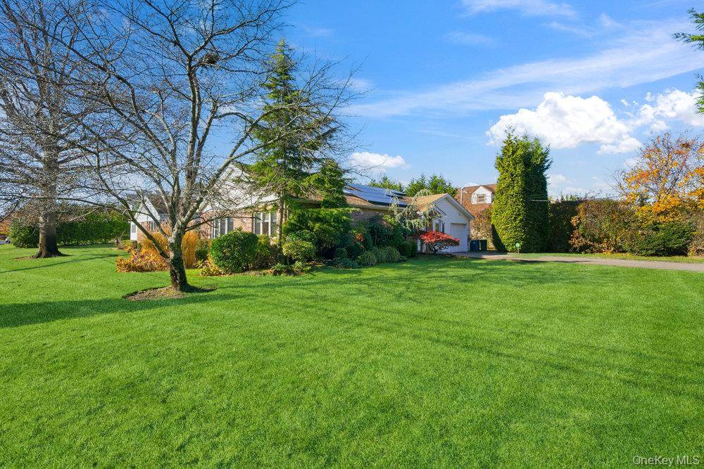 Experience North Shore living on the South Shore in this extended custom ranch located on a prestigious street in South Lindenmere.