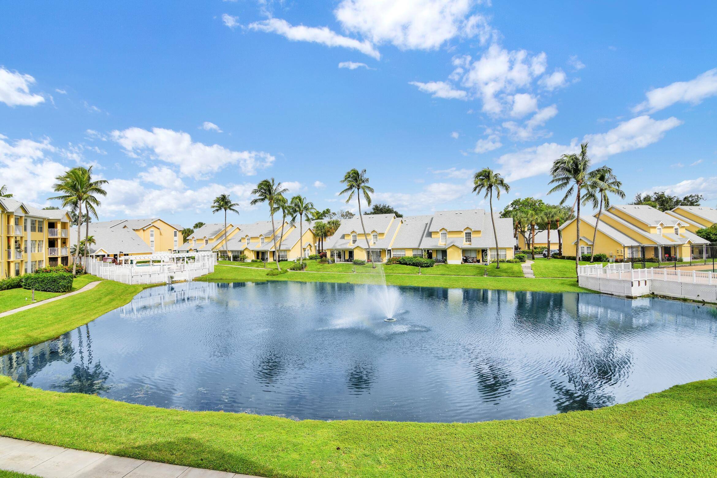 Beautiful, bright corner unit fully remodeled with oversized open gourmet kitchen, contemporary bathrooms, and a tiled balcony overlooking serene lake views.