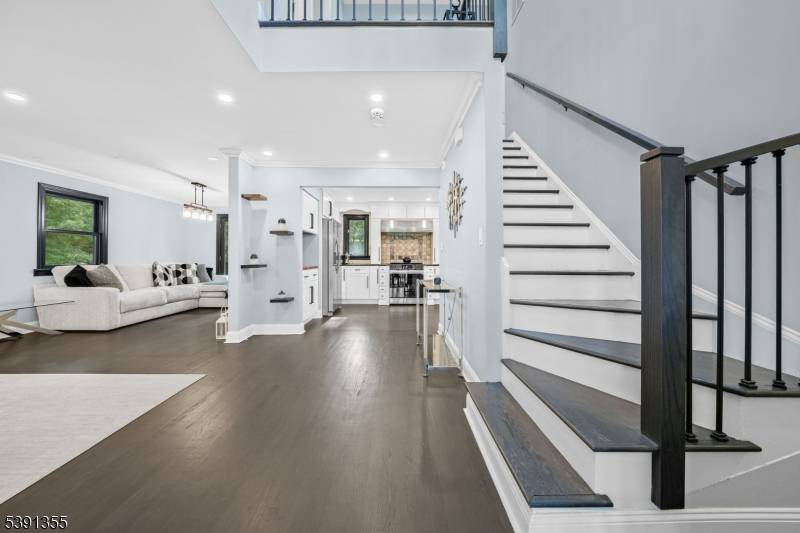 Perched atop a private hill, this North Caldwell residence beautifully blends modern elegance with everyday comfort.