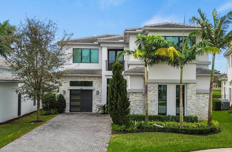Experience refined luxury in the Contemporary Vizcaya model in the prestigious Boca Bridges community.