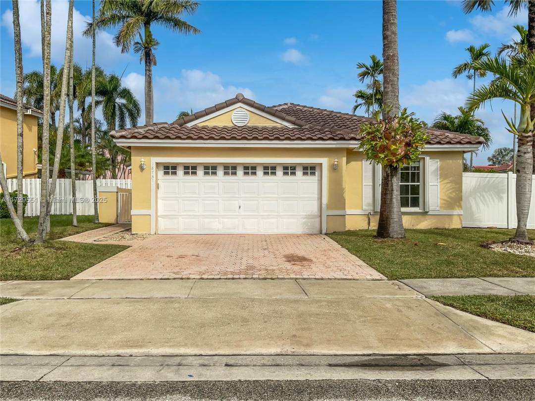 A bright welcoming foyer greets you as you enter this spacious living area with wood laminate floors and French doors leading to a screened pool and patio.