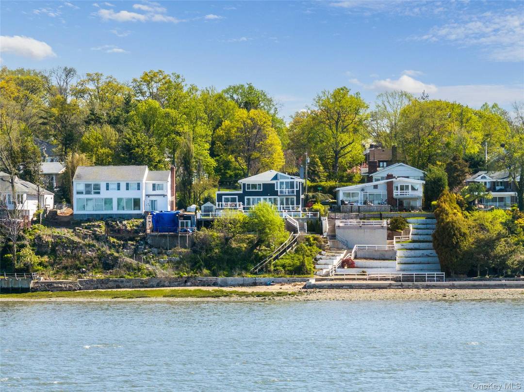 14 Shorecliff Place is a radiant waterfront Colonial nestled in the prestigious Harbor Hills enclave of Great Neck.