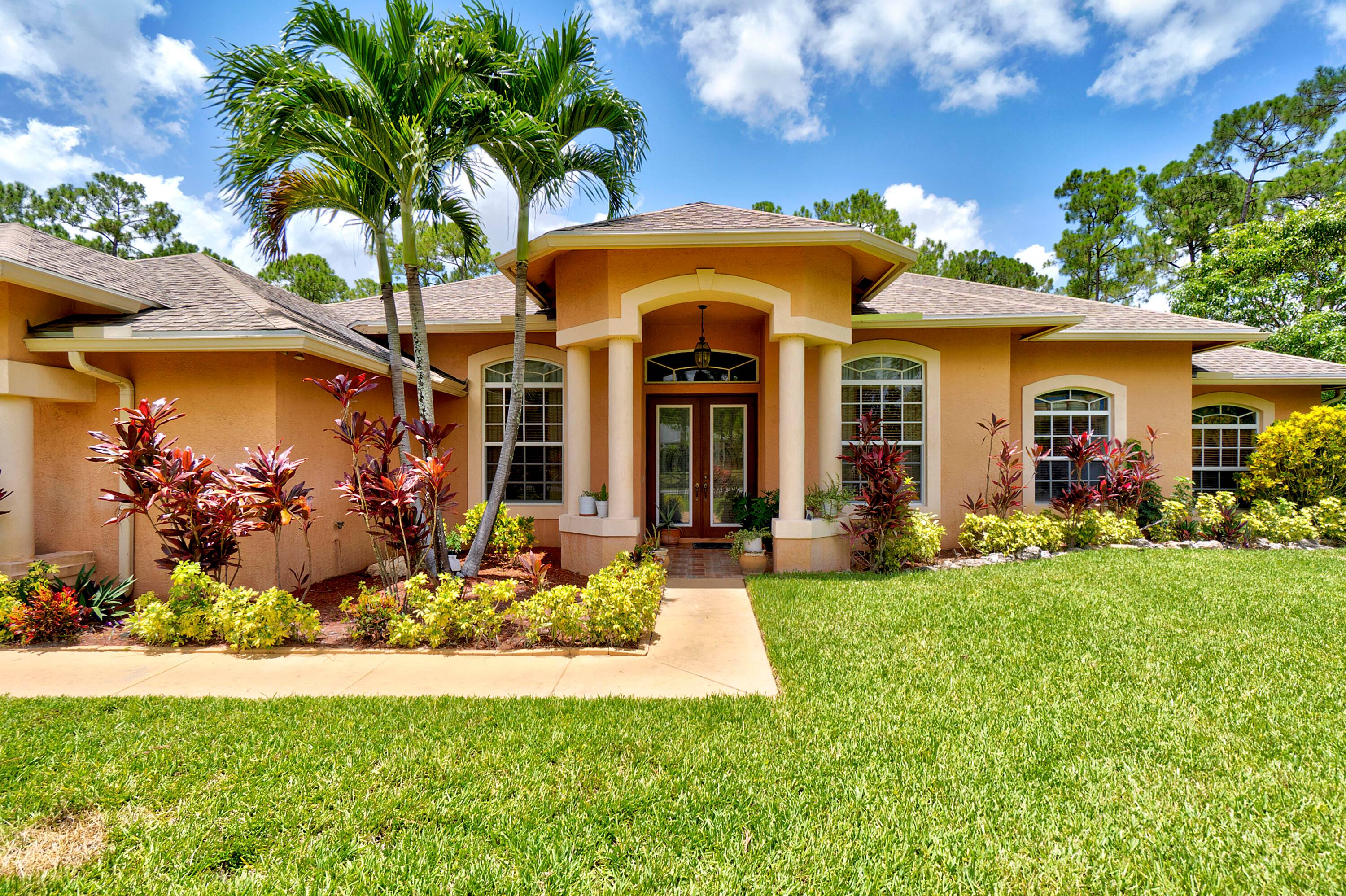 TROPICAL PARADISE ON OVER AN ACRE OF BEAUTIFULLY LANDSCAPED PROPERTY WITH LARGE POOL AND FRESH FRUIT TREES.