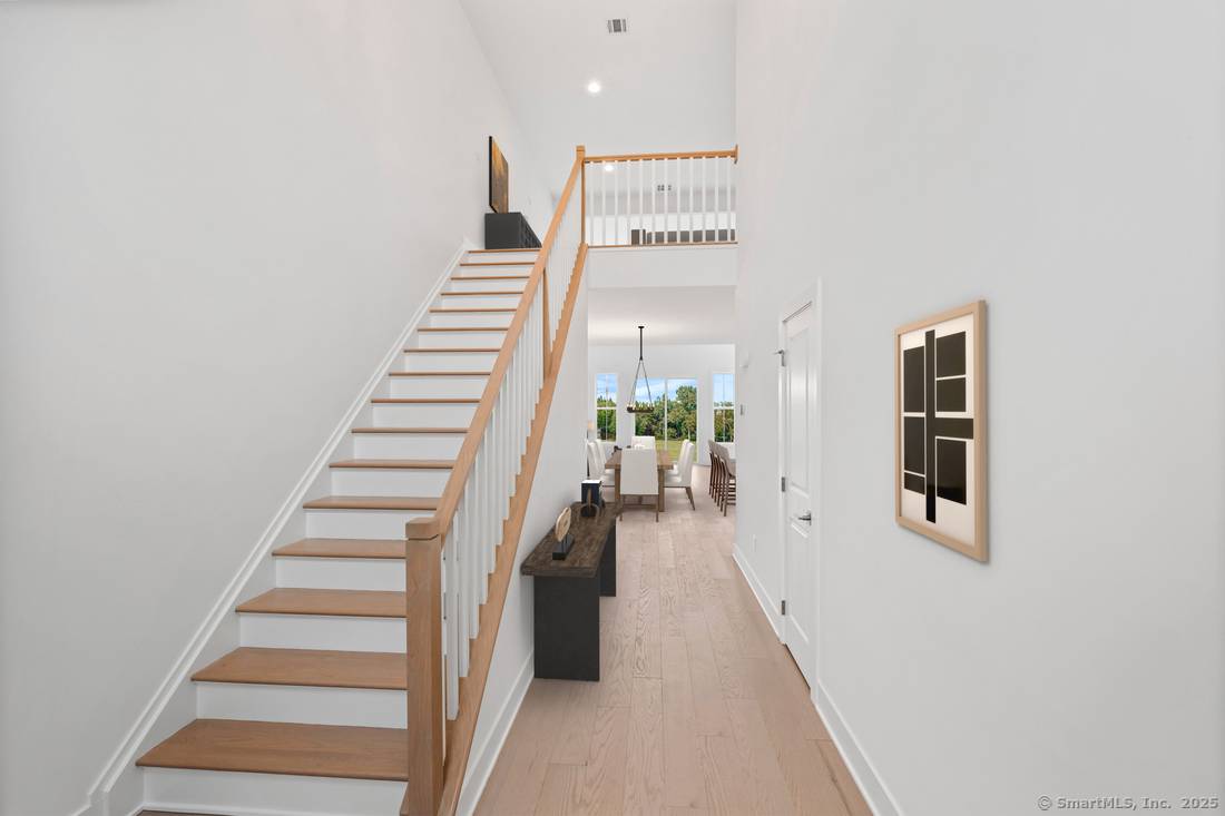 The Pierson Modern Farmhouse features a chef inspired kitchen, complete with a designer backsplash, sleek Century cabinetry, and beautiful quartz countertops.