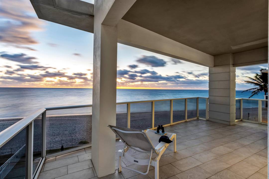 Rare oceanfront corner penthouse with sweeping views up and down the coastline, perfectly positioned along a serene stretch of beachfront.