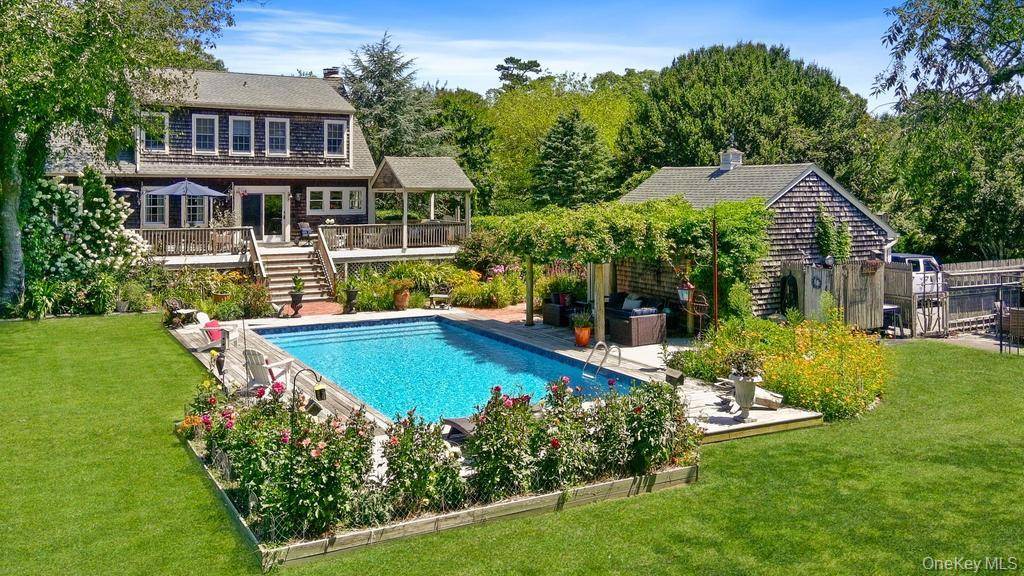 This Charming Cape is situated on a beautifully landscaped shy acre in Brookhaven Hamlet.