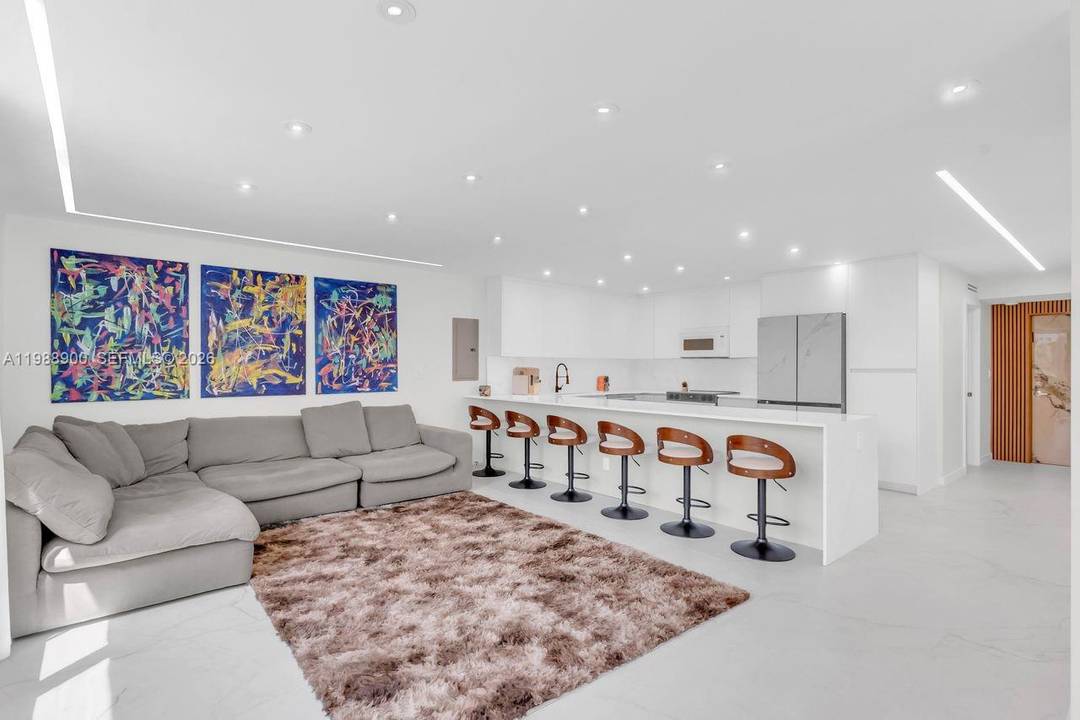 Step into modern elegance with this beautifully completely renovated residence featuring sleek porcelain tile flooring throughout, brand new impact windows and doors, and custom made closets designed for optimal storage ...