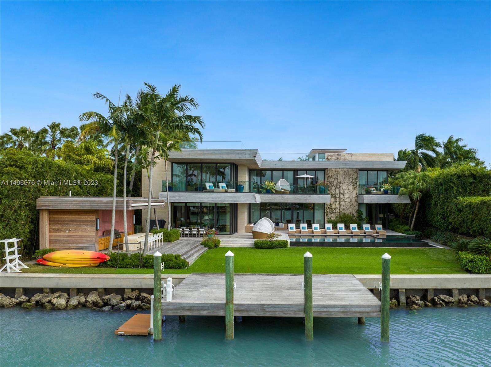 This waterfront estate on prestigious North Bay Road is a masterpiece of ultra luxe tropical modernism.