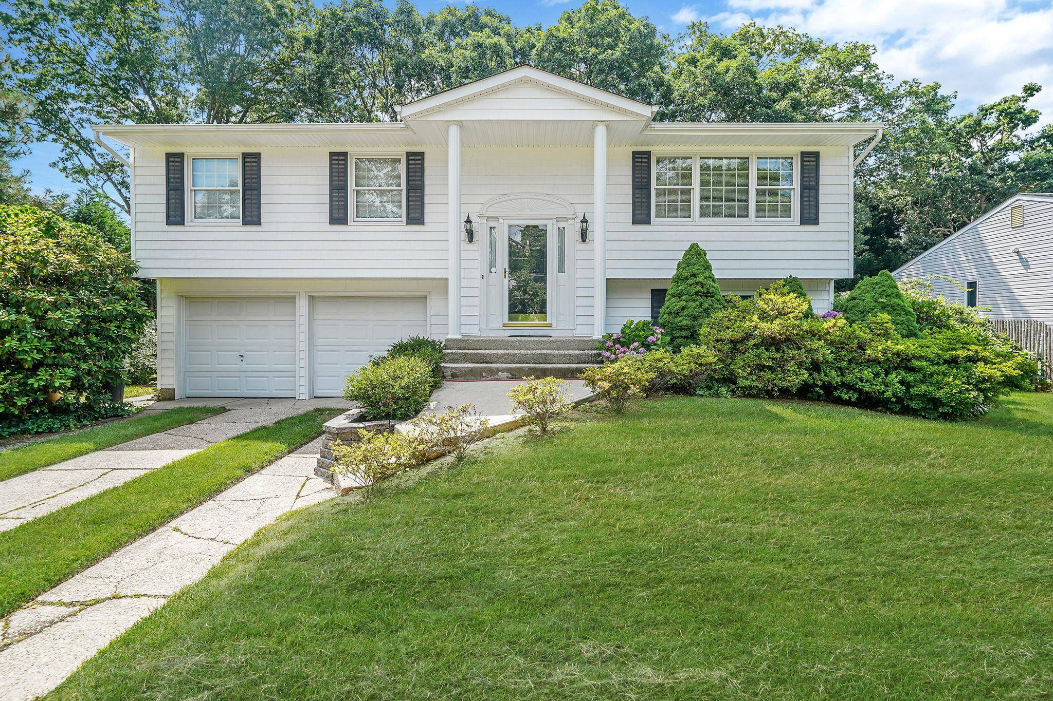 Location ! Location ! Sits this fabulous sun filled Spacious High Ranch offering 4 bedrooms, 1 full bath and 2 half bath.