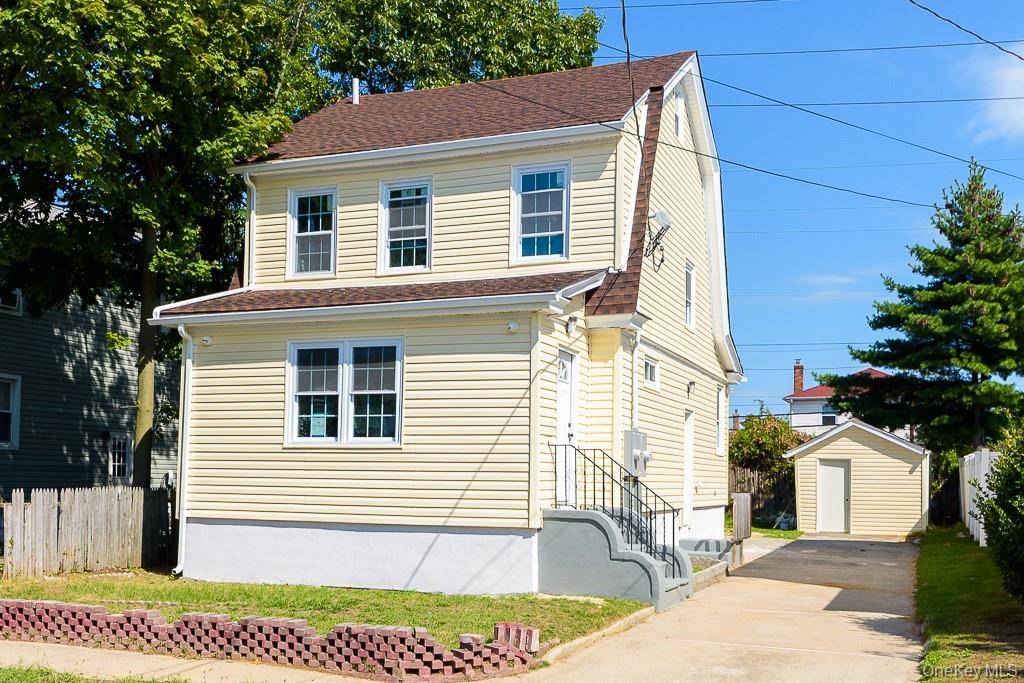 2 Family house with shed and driveway.