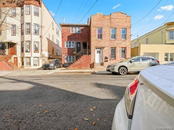 Great Location Young Legal 3family home brick frame semi detach it features 2brs apt over 2brs apt over 2brs apt plus full basement and shared driveway.