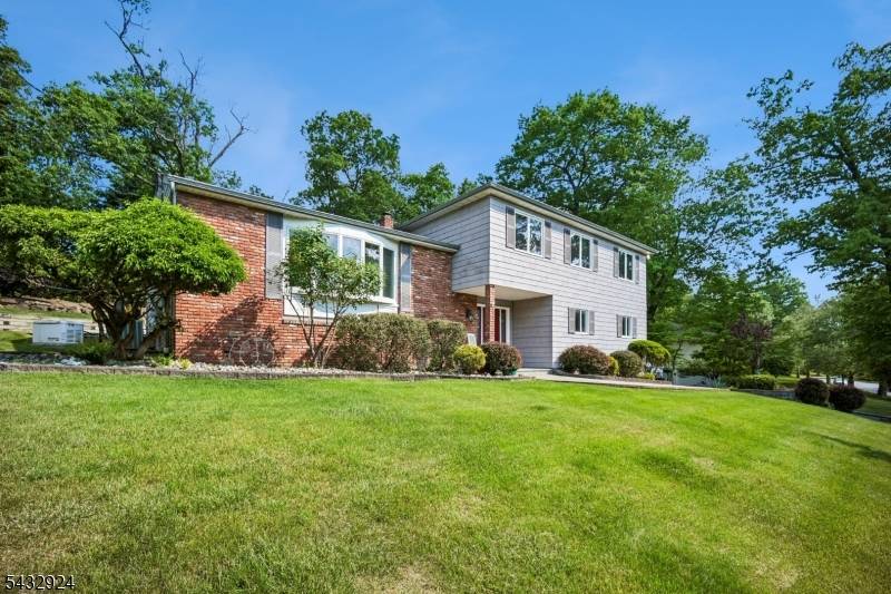 Nestled in the highly sought after Riker Hill neighborhood this expansive 4 bedroom 3 full bathroom split level home offers the perfect blend of suburban tranquility and everyday convenience.