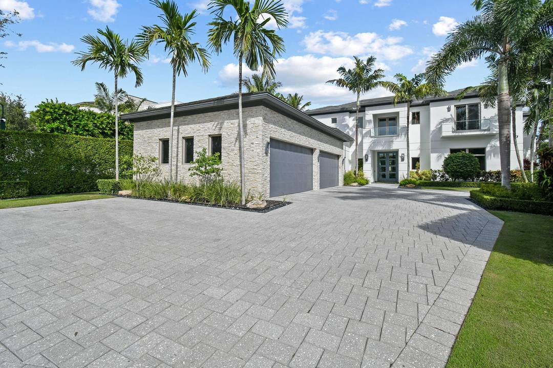 Introducing a beautifully crafted modern waterfront residence located directly on the Intracoastal Waterway in the private, gated community of Harbor Place, adjacent to The Bear's Club in Palm Beach Gardens.