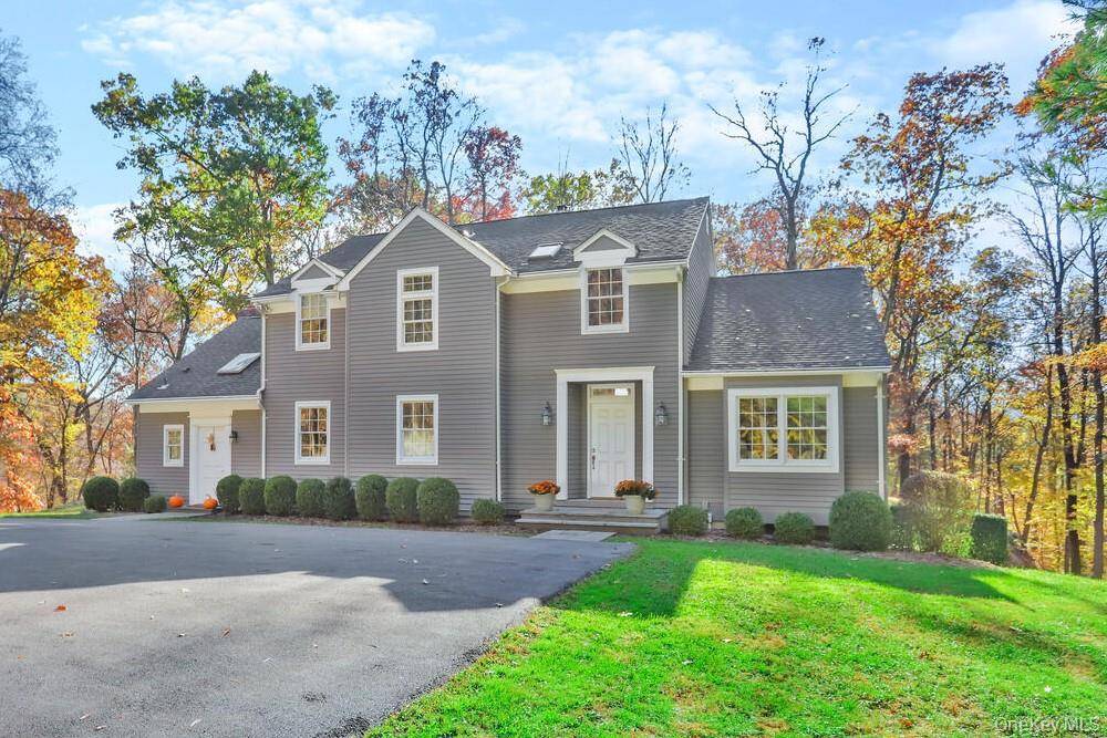 Beautifully updated contemporary colonial in a private, wooded setting !