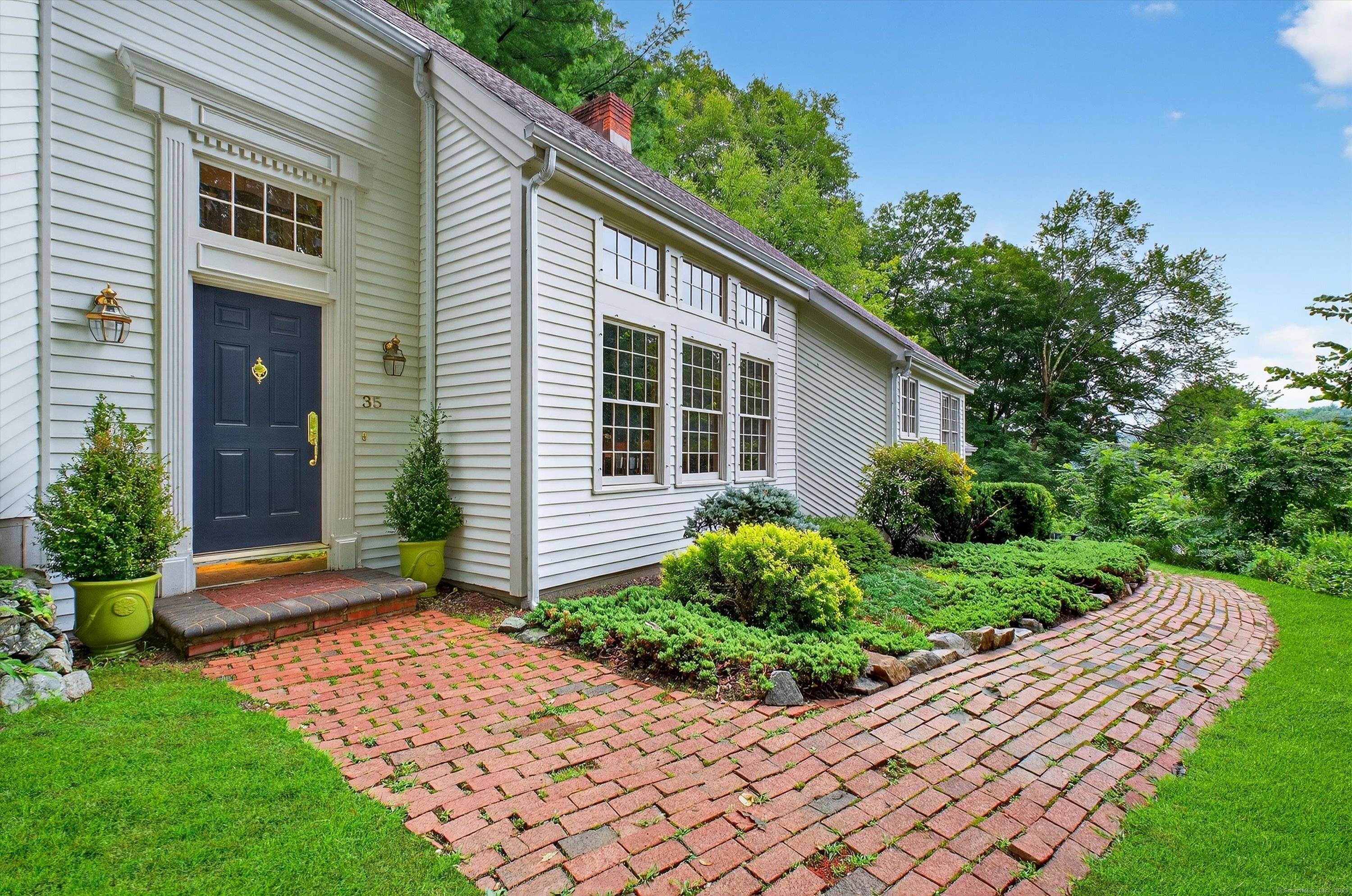 Welcome to 35 Poverty Hollow Road, an idyllic retreat nestled in southwest Newtown with sweeping views of the scenic Red Gate Farm.