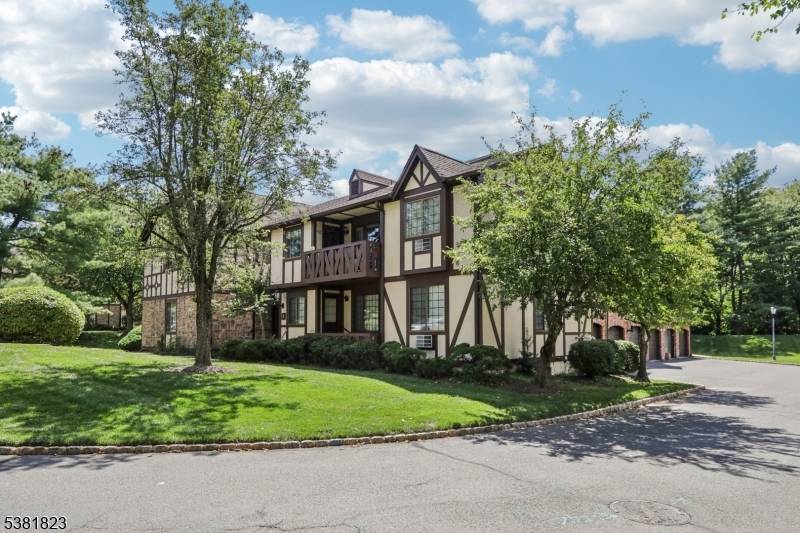 Welcome to a beautifully updated residence where classic Tudor style architecture and lush landscaping create timeless curb appeal.