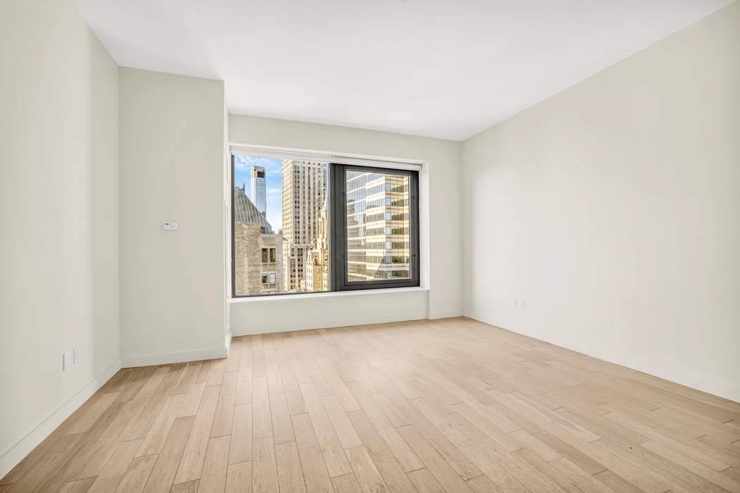 Motivated Seller Step into this bright and airy studio, where natural light pours in through oversized windows, framing stunning views of the Financial District and the East River.