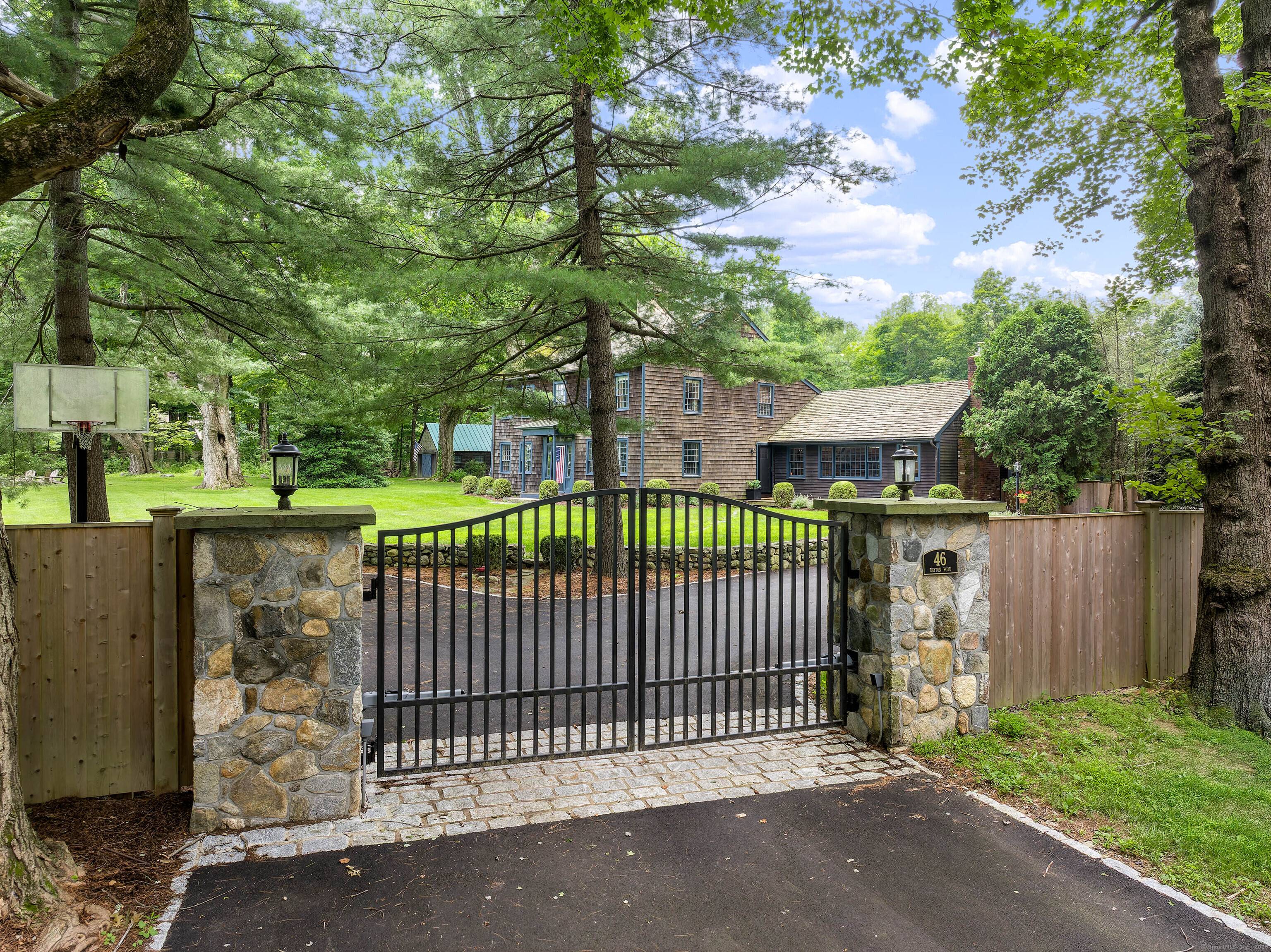 Enter this quintessential country retreat through stately stone pillars and a gated entry, where a beautifully renovated and expanded c.