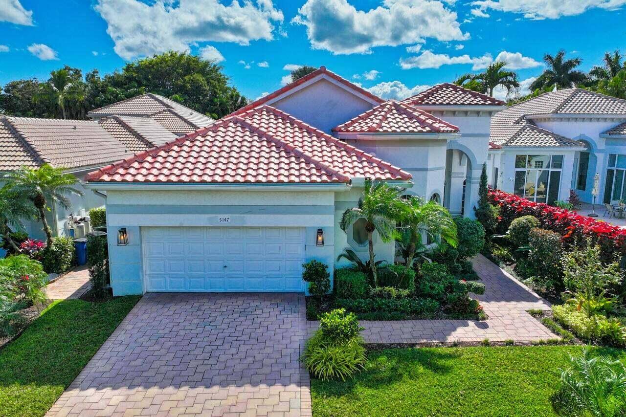 Welcome to your dream home in the exclusive Courtside subdivision of Broken Sound Country Club.
