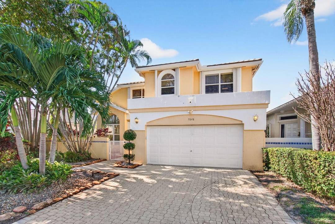 7848 Travelers Tree Drive is a bright and inviting two story residence located within the highly sought after, gated community of Boca Pointe.