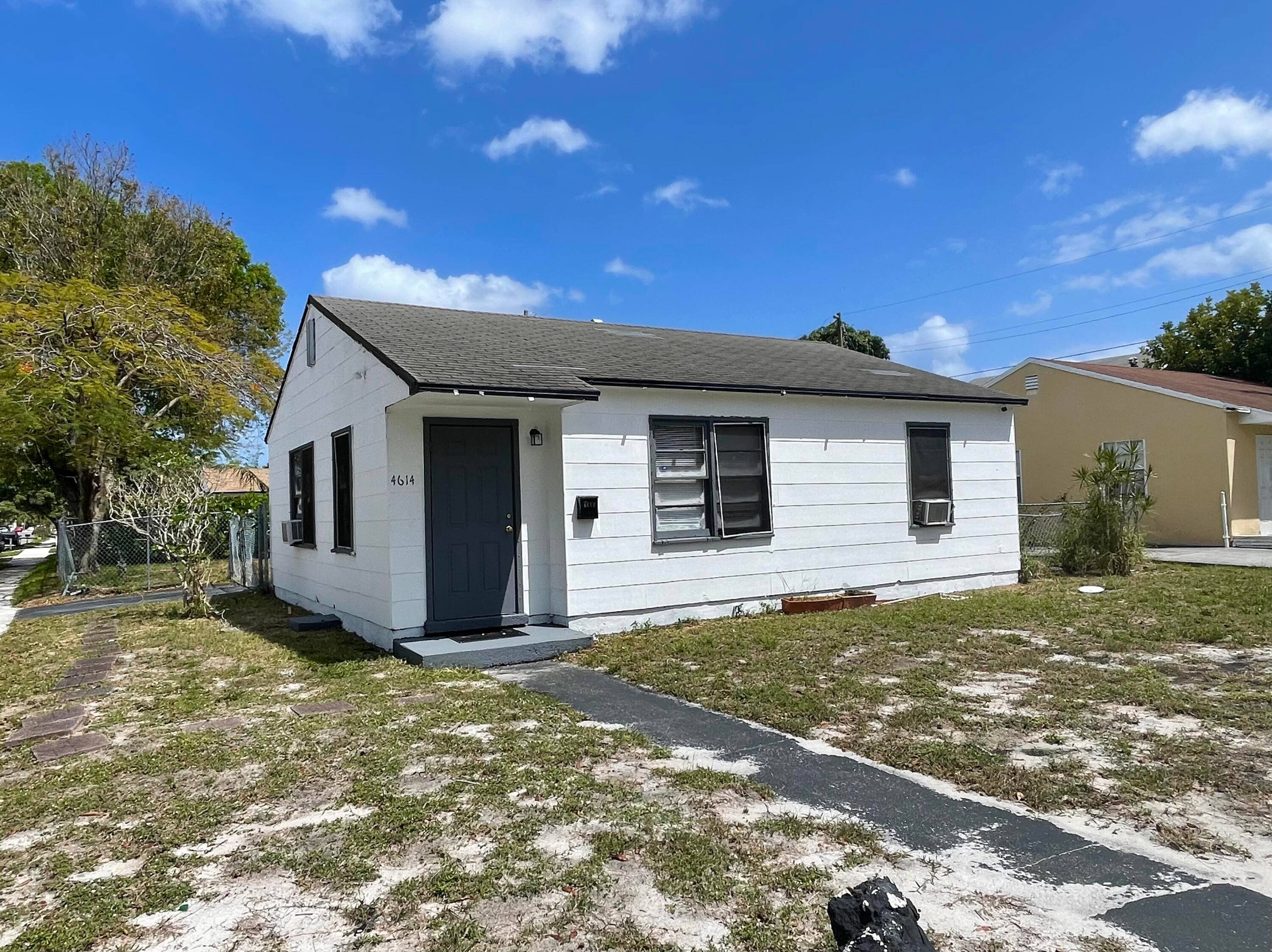 Situated on a corner lot in a picturesque neighborhood, this lovely house boasts a spacious backyard.