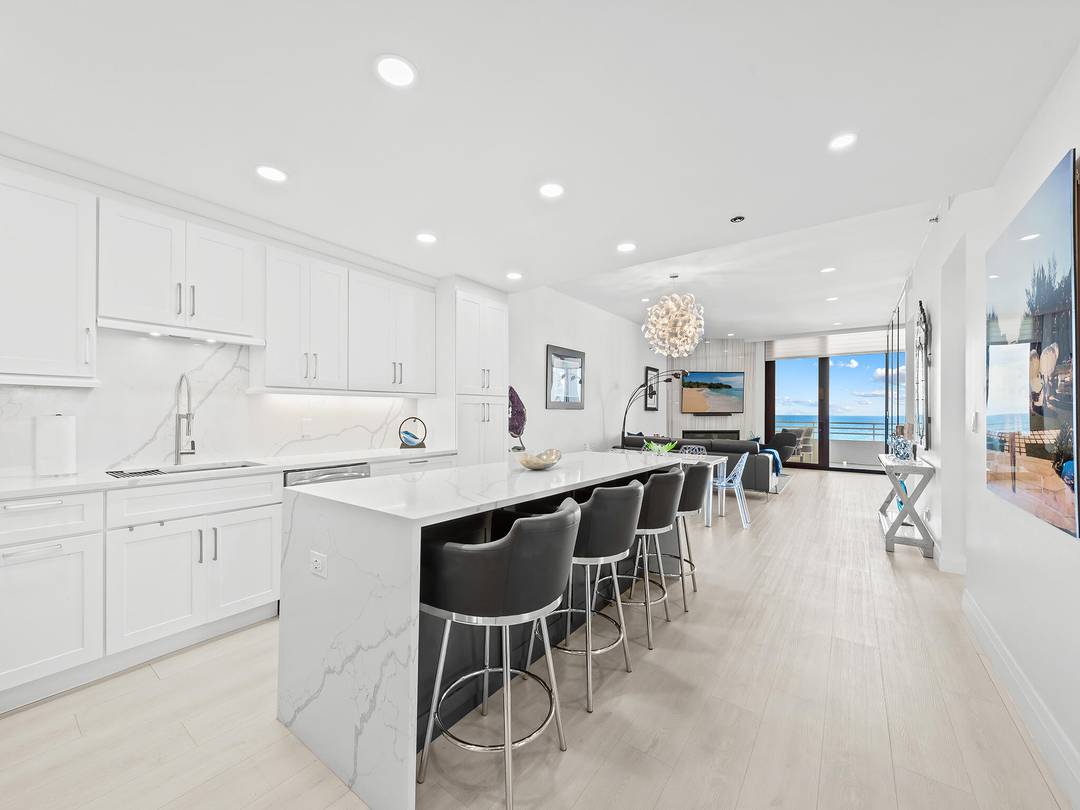 Unobstructed Ocean Views from this totally redesigned turnkey Lower Penthouse residence !