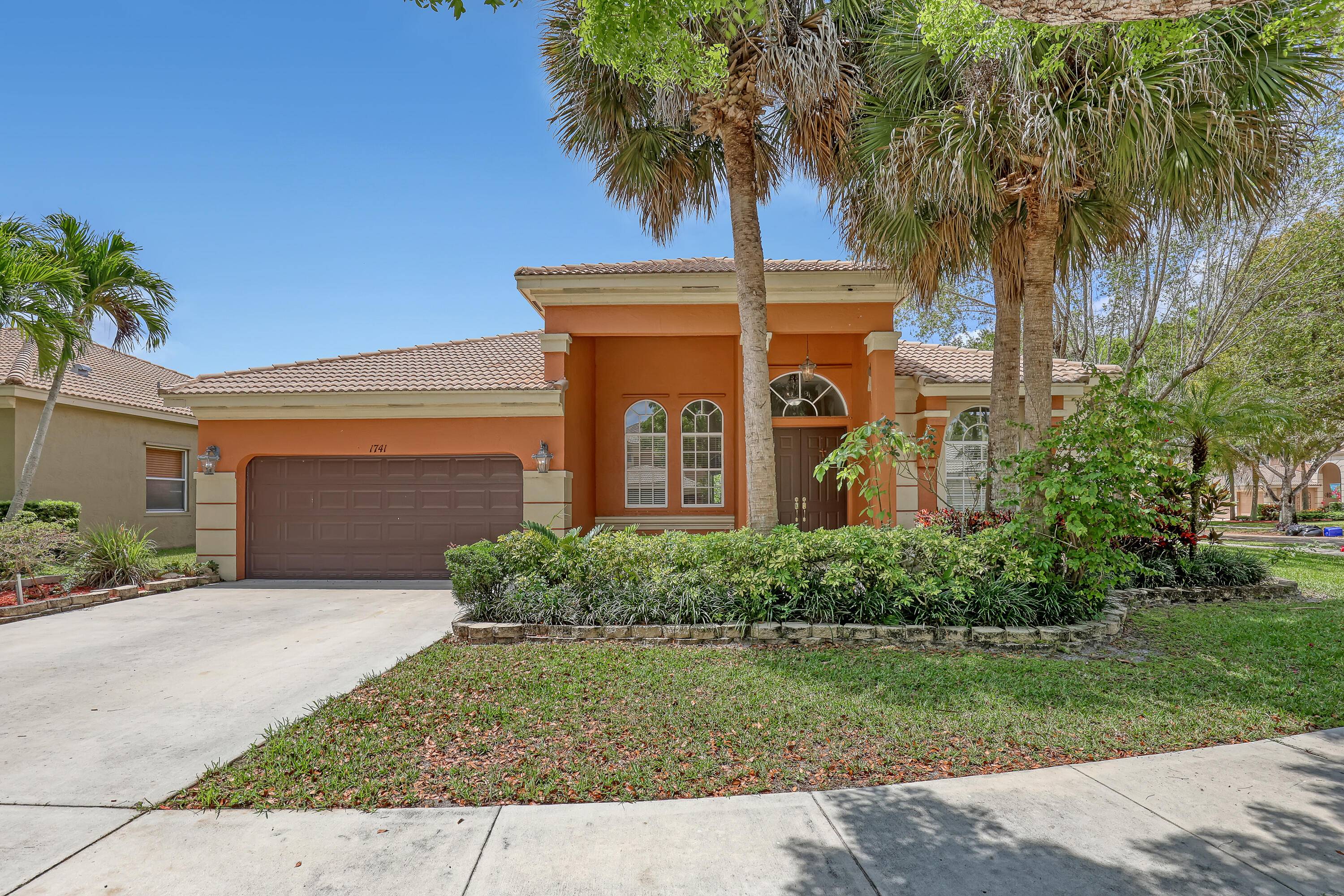 Welcome to this charming one story home in Madison Green, Royal Palm Beach's most sought after gated community.