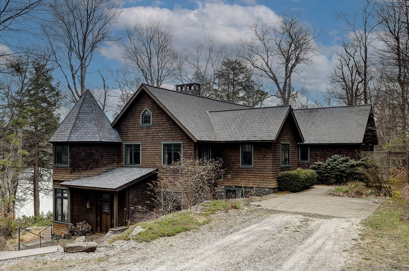 Tower Hill house sits on 7 acres with 800 feet of frontage along the western shore of Doolittle Lake in Norfolk, CT.
