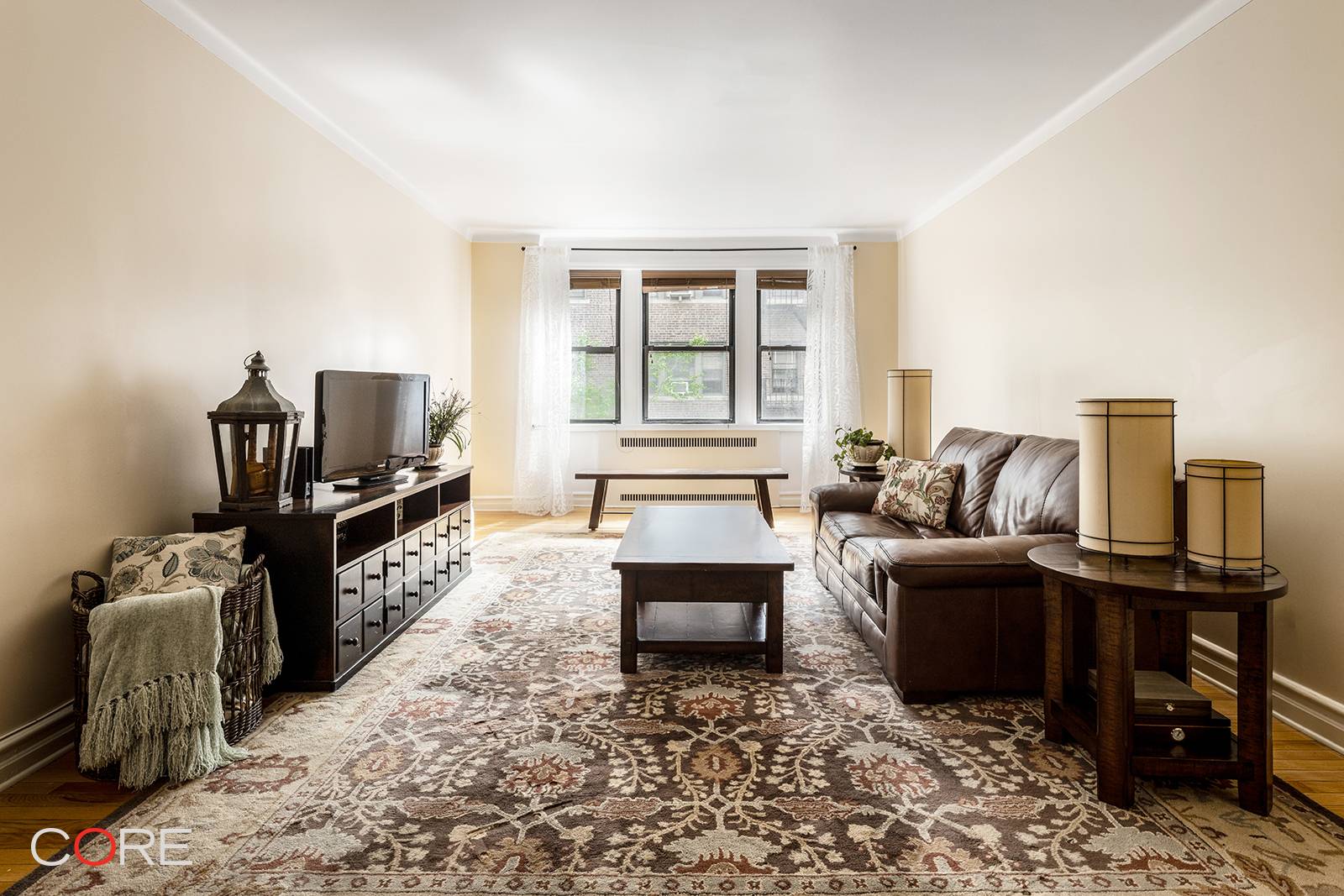Bask in pre war charm as you enter this home, featuring impeccably preserved original hardwood floors, soaring nine foot ceilings, and elegant arched doorways complete with freshly skim coated walls ...