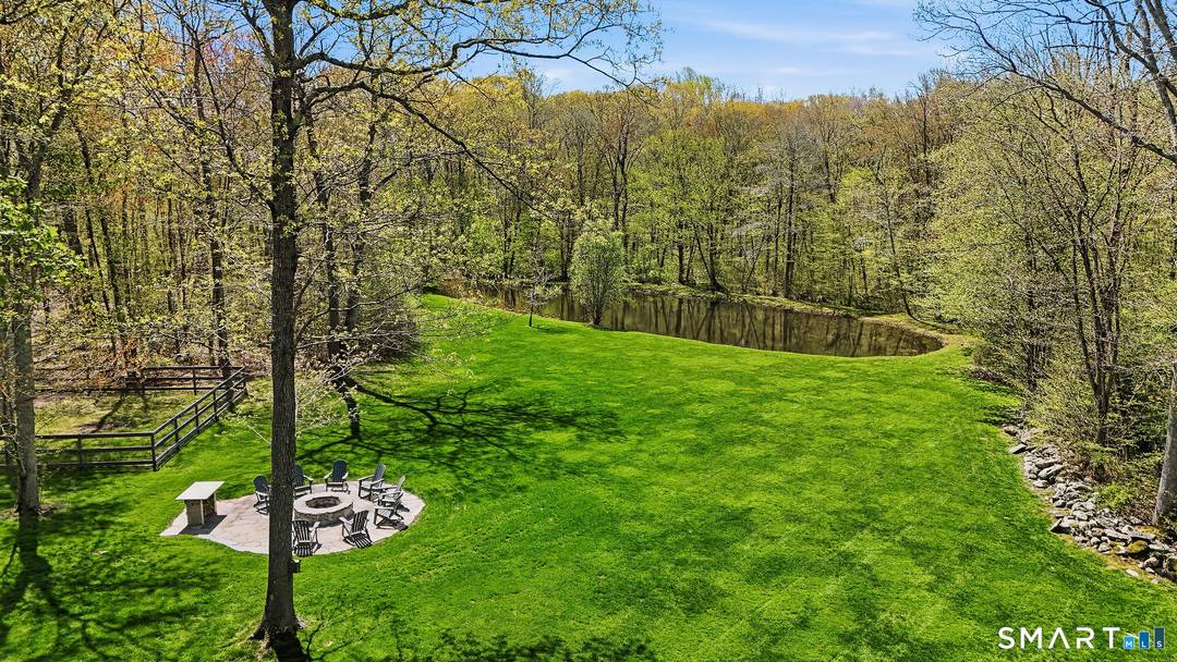 Welcome to 61 Mystic Road, a fully restored and thoughtfully updated log cabin set on approximately 15 private acres in picturesque North Stonington, CT.