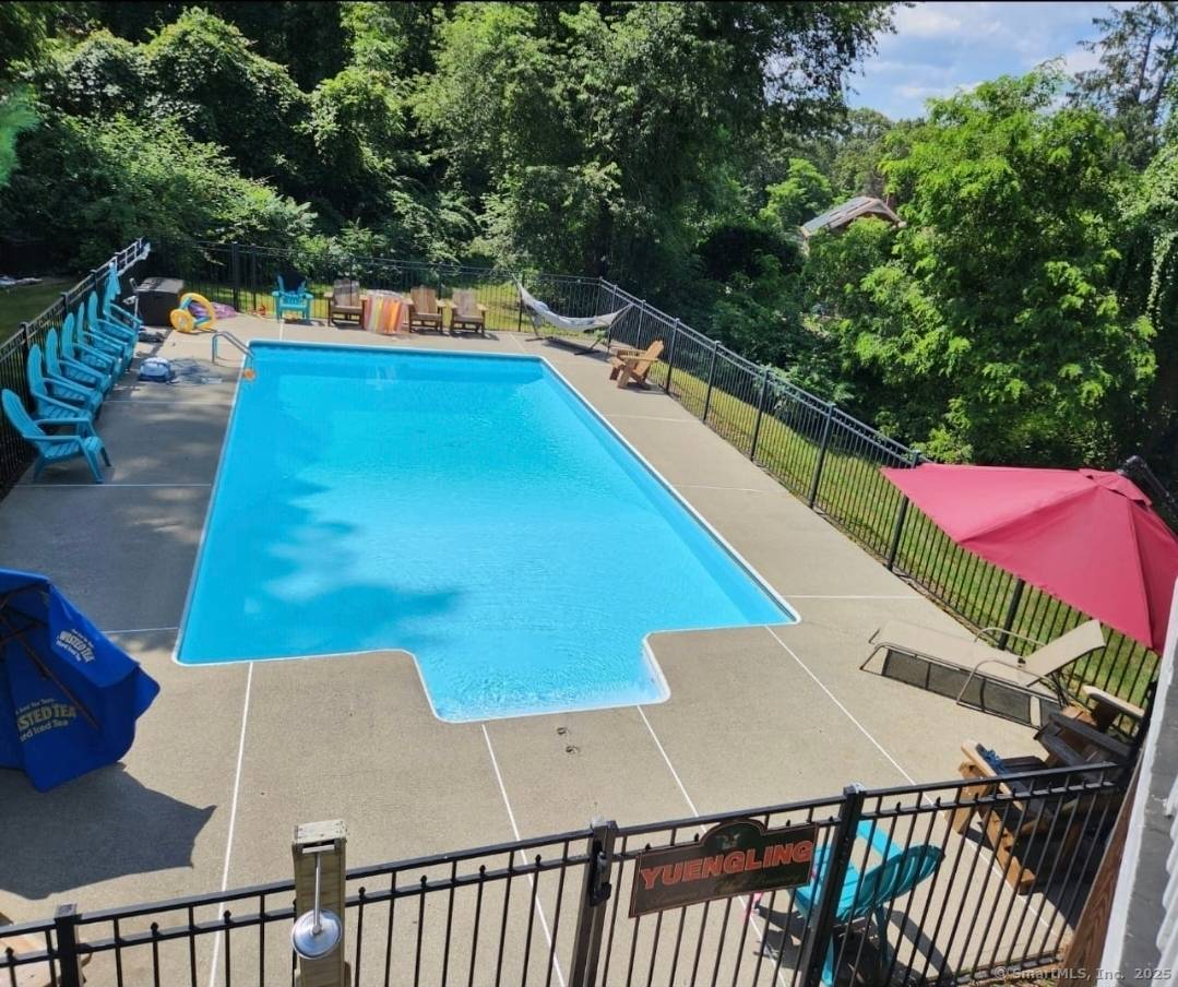 Nestled at 5 Bittersweet Drive in Gales Ferry, CT, this impressive property showcasing 4 5 bedrooms, two spacious primary suites, 3 full baths, a heated inground saltwater pool, outdoor hot ...