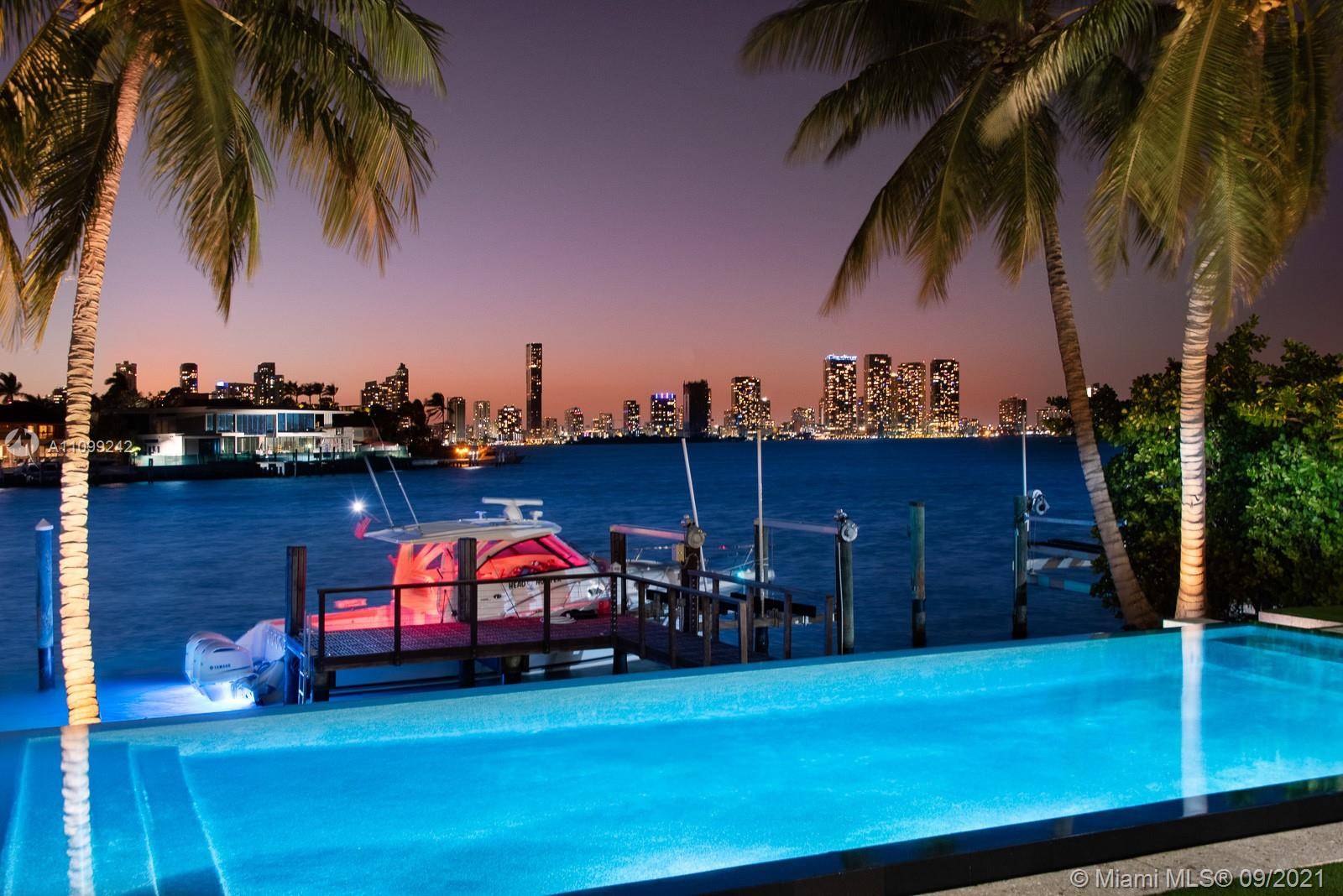 Stunning tropical modern home with wide open west bay views.