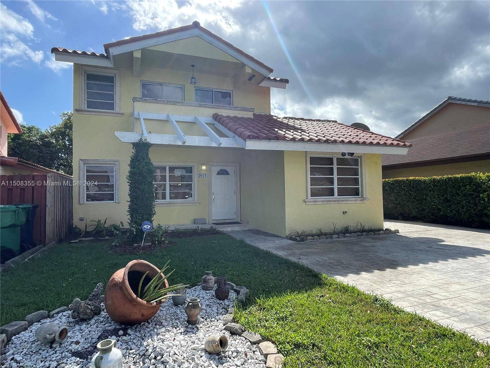 Two story, waterfront home on SW 8th St Canal way recently renovated with a large patio yard.