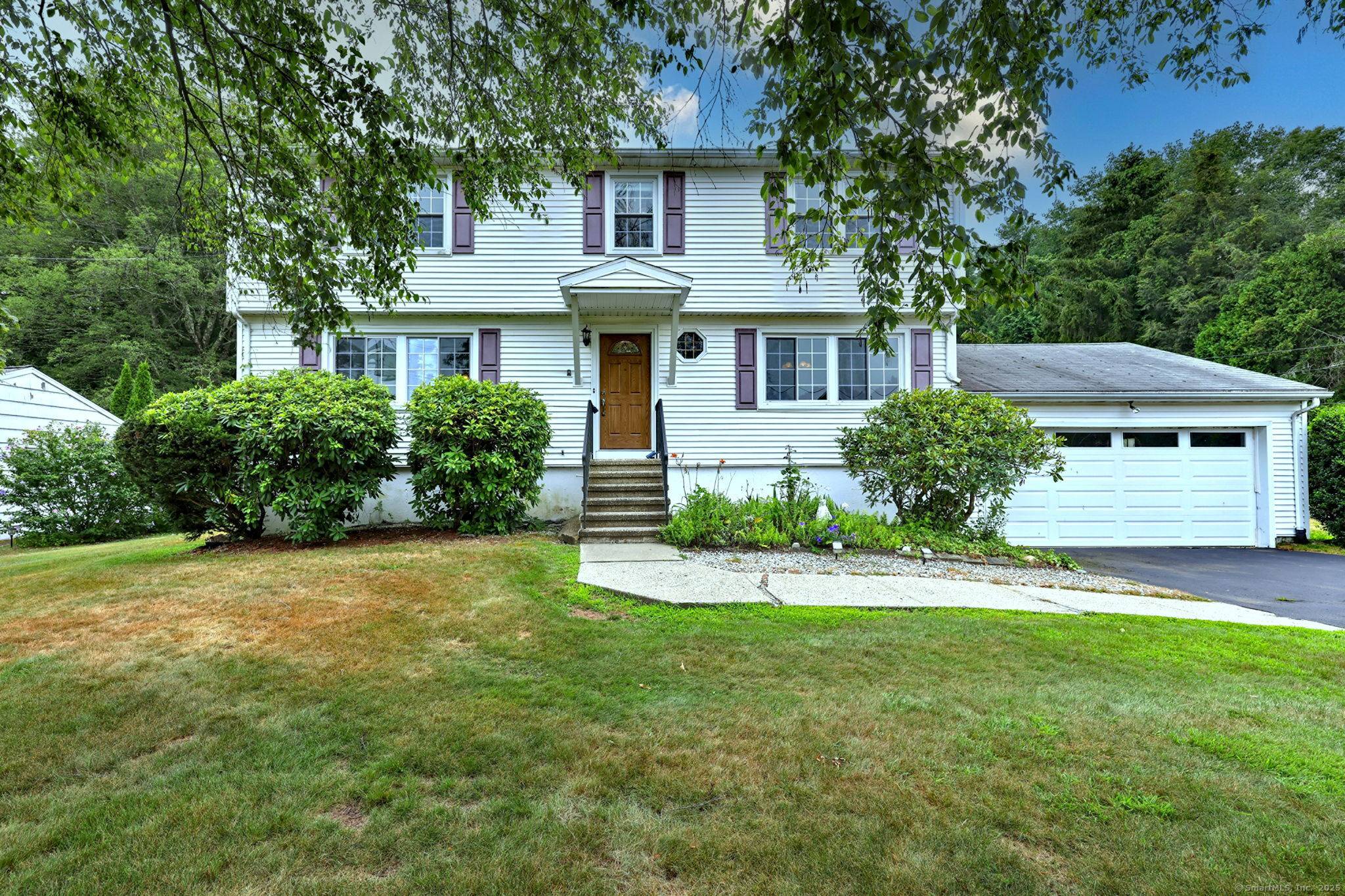 Nestled on a level, lightly wooded lot, this stately Colonial residence exudes timeless charm and vintage appeal.