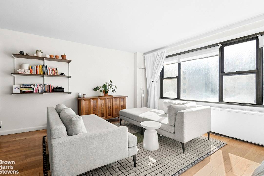 This beautifully gut renovated, oversized alcove studio is bathed in natural light from south facing windows, offering open views of the city's rooftops, buildings, and sky.