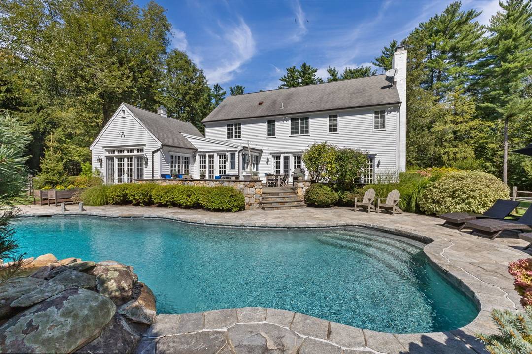 A storybook entrance framed by classic stone walls opens to four flat, park like acres leads you to this thoughtfully updated five bedroom Colonial layered with warmth, character, and the ...