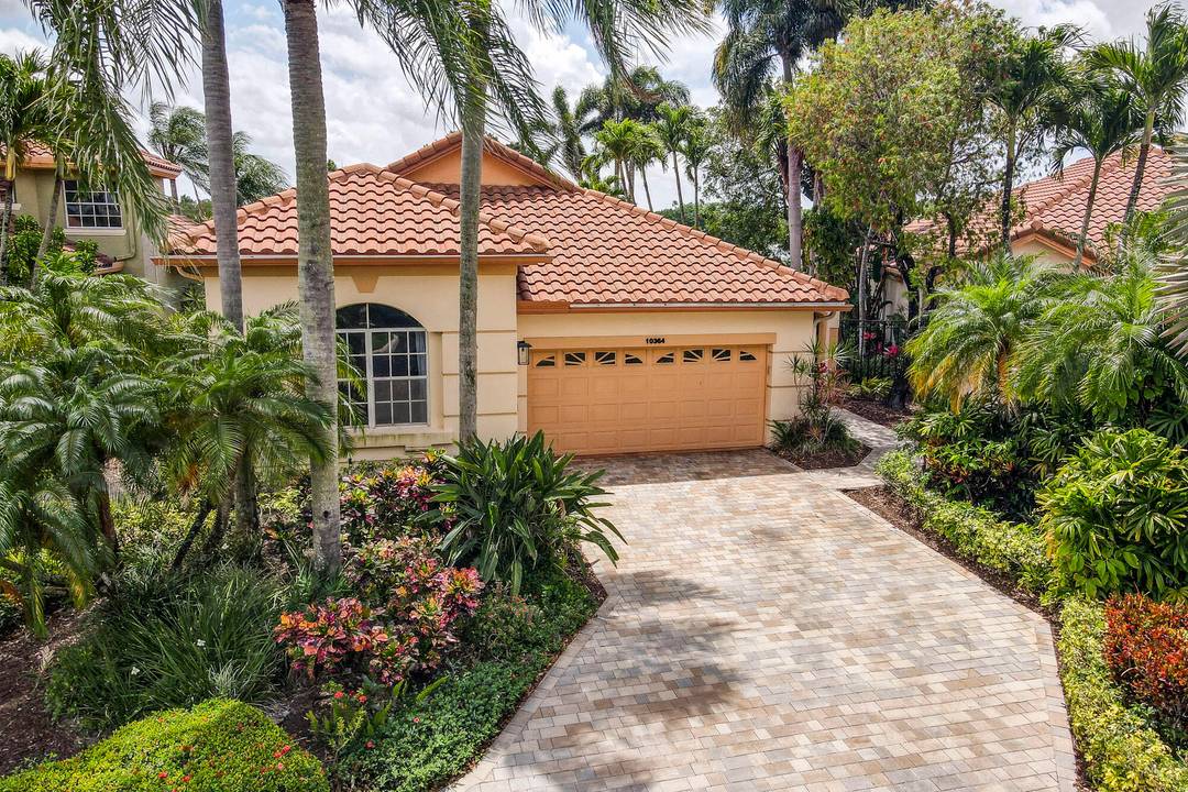 Located on a quiet cul de sac, this beautifully maintained home offers stunning golf course views and lush tropical landscaping.