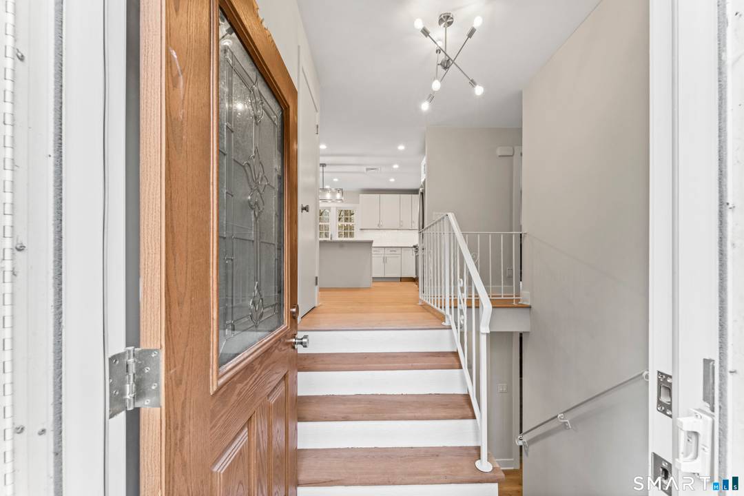 Located close to the Lake Club on a private secluded lot bordering Parting Brook.