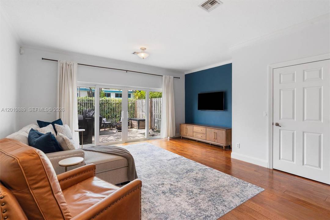 Private gated townhome in Victoria Park featuring an open concept kitchen with quartz countertops, breakfast bar, stainless steel appliances, and custom cabinetry.