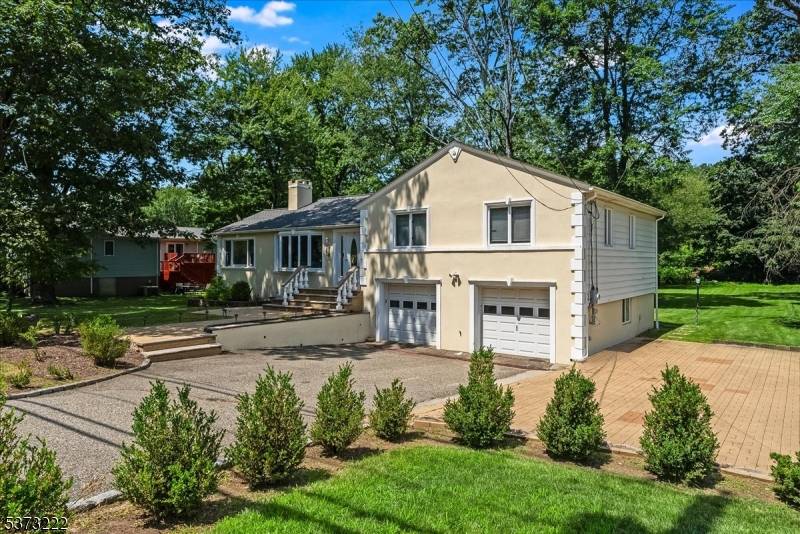 Welcome to this beautifully updated 4 bedroom, 3 bathroom split level home set on a lush half acre lot in one of Essex County's most desirable towns.