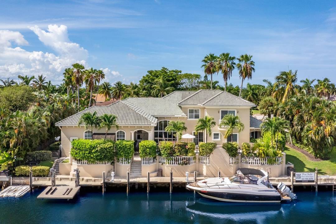 Tucked within the prestigious enclave of Boca Bay Colony, this waterfront estate blends timeless elegance with resort style living.