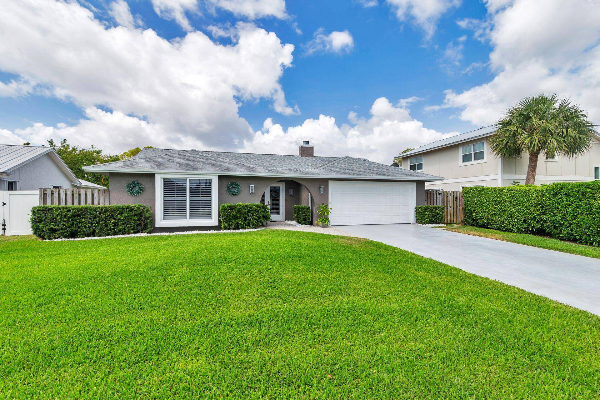 Nestled in one of PB Gardens most desirable communities, this beautifully renovated home blends modern luxury with timeless coastal charm.