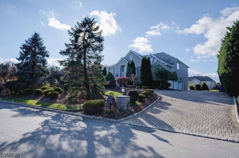 A unique opportunity to enjoy a magnificent custom home with 4 sides of stone exquisite architecture features through.