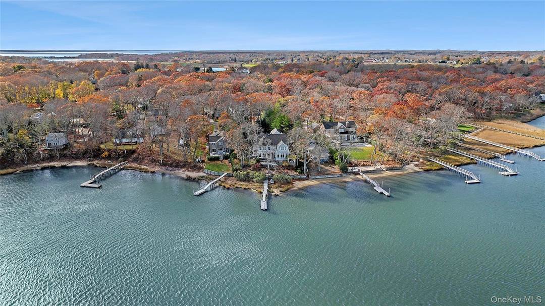 This stunning waterfront estate presents a unique opportunity to create a generational compound, complete with a boater's lifestyle, thanks to its private dock and ample outdoor entertaining space.