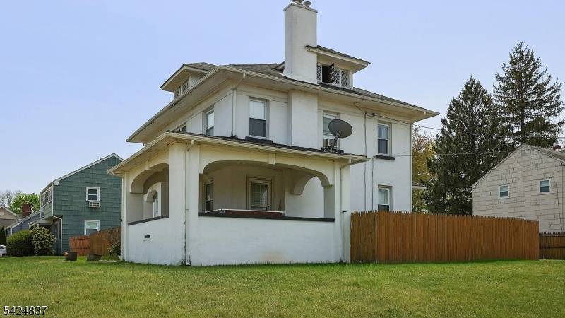 Charming Colonial style home, distinguished by its classic stucco exterior and generous interior living space.